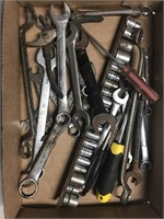 Tray containing several wrenches, sockets, pliers