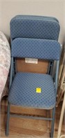 4 blue folding chairs cloth bottom and back