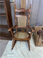 Vintage Cane bottom/back wood rocking chair.
