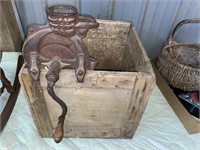 Old corn sheller on wood box.