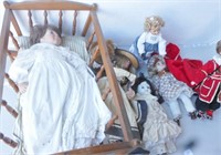 Several dolls and wooden doll cradle