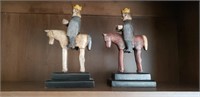 2 wooden men on horse carvings