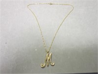 Gold tone necklace with letter M initial