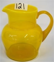 Yellow water pitcher, signed, 7"