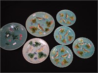 Seven turquoise majolica plates with birds,