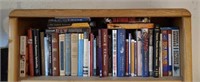 Shelf of assorted books, Tom Brokaw, Bill Cosby,