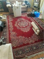 Large red wool area rug and small blue area rug.