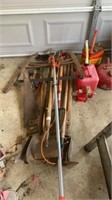 Yard season tools. Buck saw, shovels, gas cans,