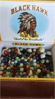 Cigar box of marbles, at least 8 shooters.Black