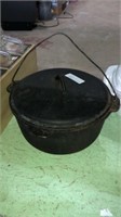 Cast iron pot with lid and handle. Approx 12 inch