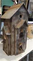 Rustic birdhouse with old rusty tin dormers