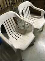 Four plastic lawn chairs