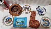 group of souvenir ashtrays around the world