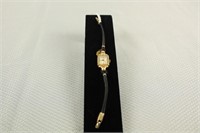 TILMORE LADIES WRIST WATCH WITH A 14K YELLOW GOLD