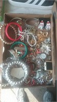 Flat of a variety of costume jewelry