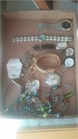 Flat of costume jewelry including several watches