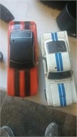 Diecast Mustang and plastic Camaro toy cars