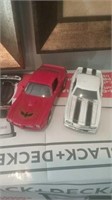 Diecast red firebird and white with black stripe