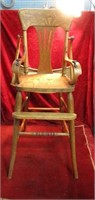 Antique wood high chair w/cast iron brackets.