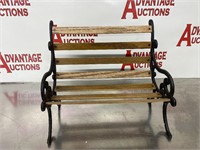 Small wrought iron and wood slat bench.