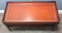 VTG. LEATHER TOP COFFEE TABLE ON WHEELS