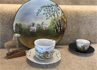 Goat plate, bull cup and saucer, goat cup and