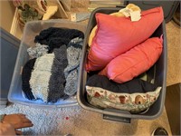 Two totes of throws and pillows