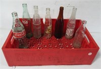 Baby blanket and Coke-Cola crate with bottles