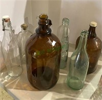 8 vintage bottles including two brown jugs, wine