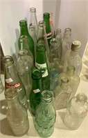 About 30 vintage bottles including soda bottles,