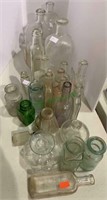 25 vintage glass bottles including some small