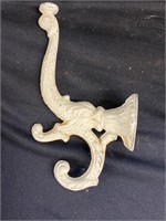 Cast iron dolphin coat hooks. 8 inches high. Six