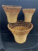 Set of three wicker baskets with metal frames and