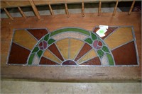 Stained glass transom with arched floral design