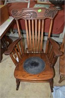 Early carved pressed back wood rocking chair with