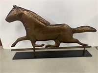 Horse figure made of metal on iron stand
