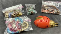 Four Bags Costume Jewelry, Ladybug, and Basket