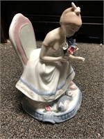 Porcelain woman sitting with flowers figurine