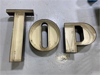Three large neon sign letters: TOP, POT, OPT
