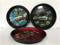 Three souvenir round trays