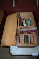 Early wooden shoe shiner box with shaving goods.