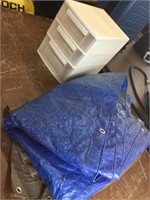 2 tarps and dirty plastic drawers