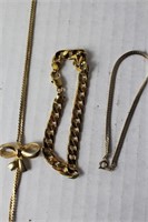 misc lot of gold jewlery , single gold bow necklac