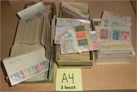 A4- 3 boxes of sorted foreign stamps in wax