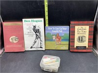 4 golf books and golf tees