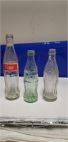 3 coke bottles