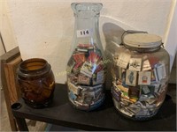 large glass bottle, amber jar and pickle jar full