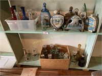 several decanters, bottle, and figurines