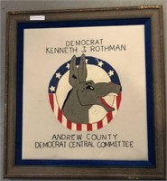 Framed political needlepoint memorabilia.