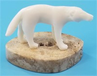 Ivory carving of a wolf by Leonard Savage on walru